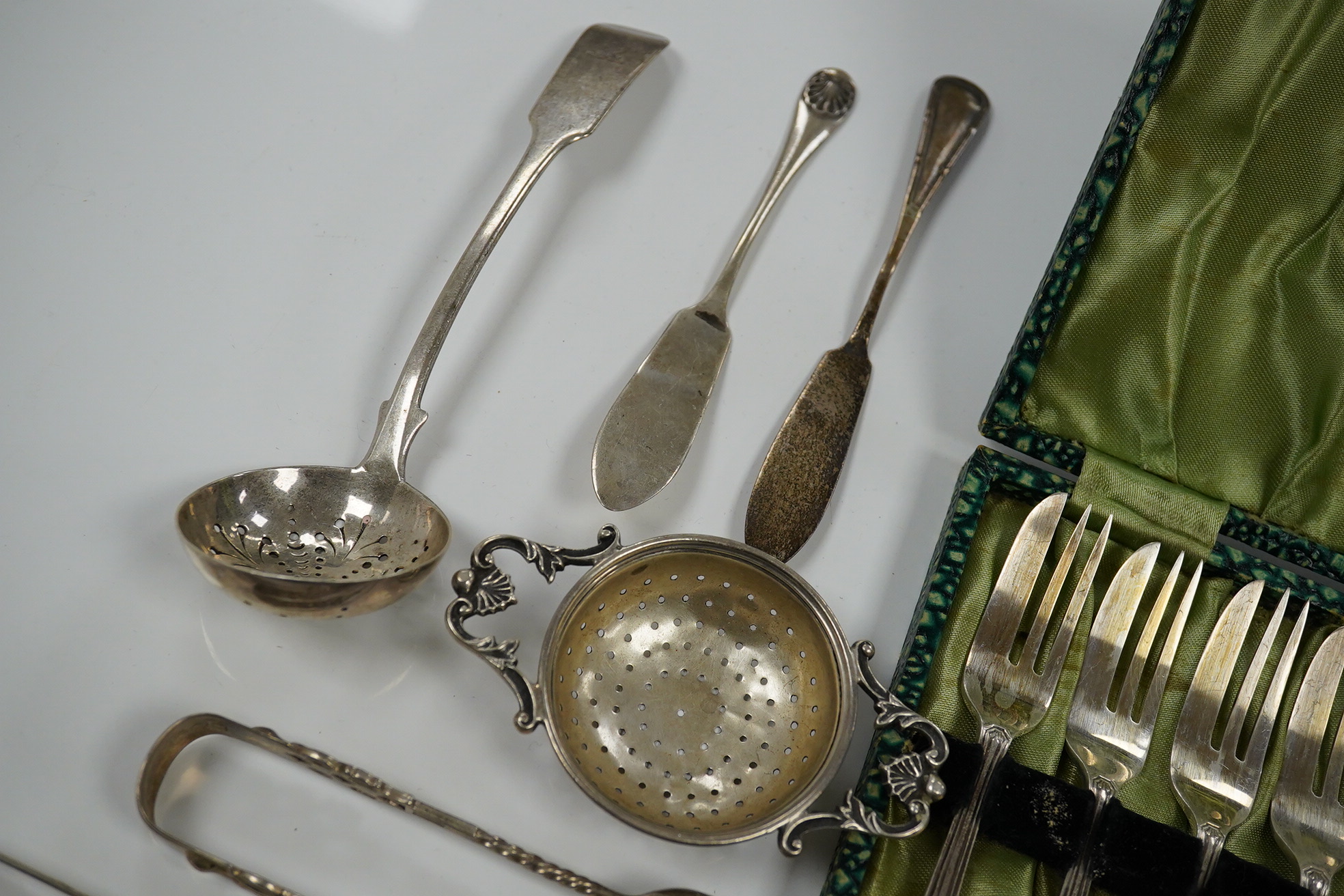 Sundry silver including cake forks, sifter ladle, salt spoons, Victorian silver handled bread knife, etc. Condition - poor to fair